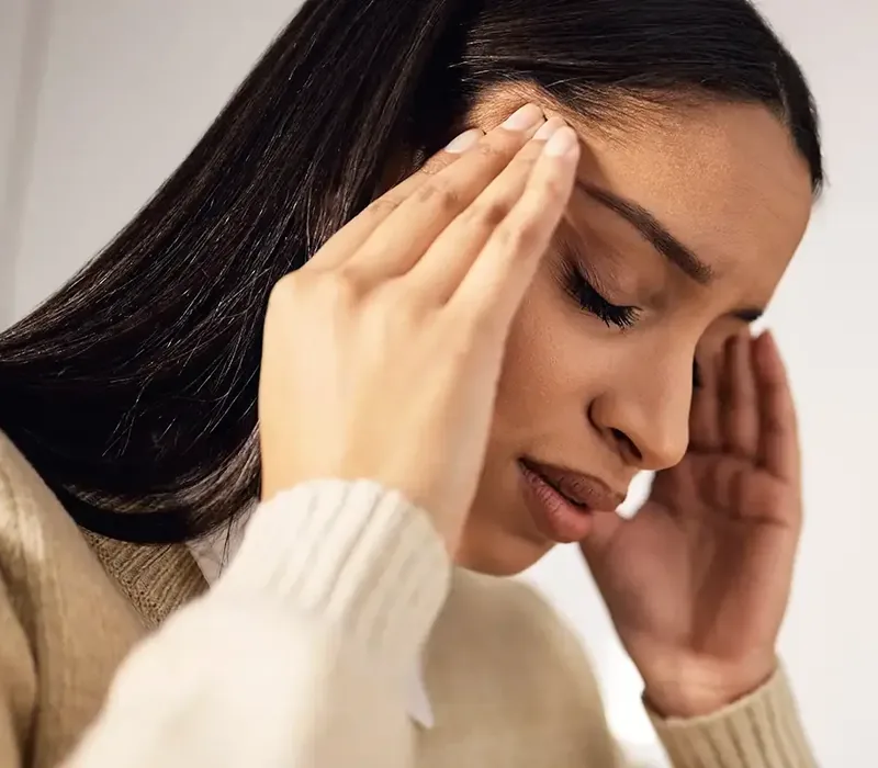 A person steadying themselves during a dizziness episode