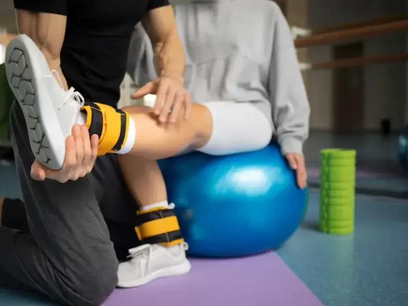 A therapist guiding a patient through post-surgical range of motion work