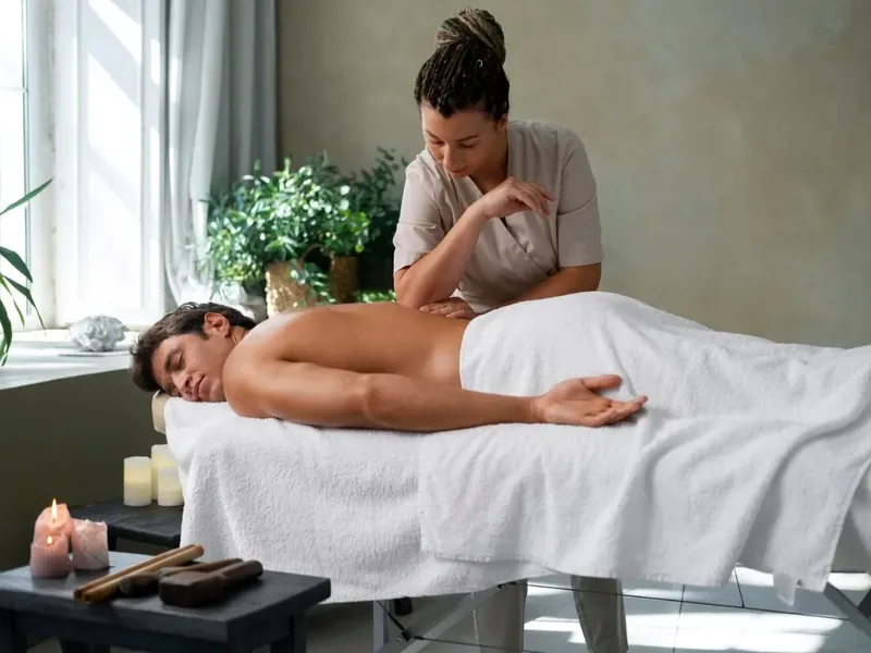 Doctor of Physical Therapy holding slow, sustained myofascial pressure along a patient's upper back