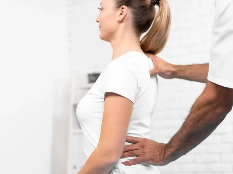 Doctor of Physical Therapy applying graded hands-on soft tissue mobilization to a patient's shoulder