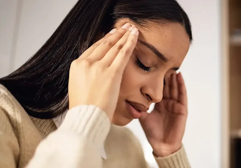 A person steadying themselves during a dizziness episode